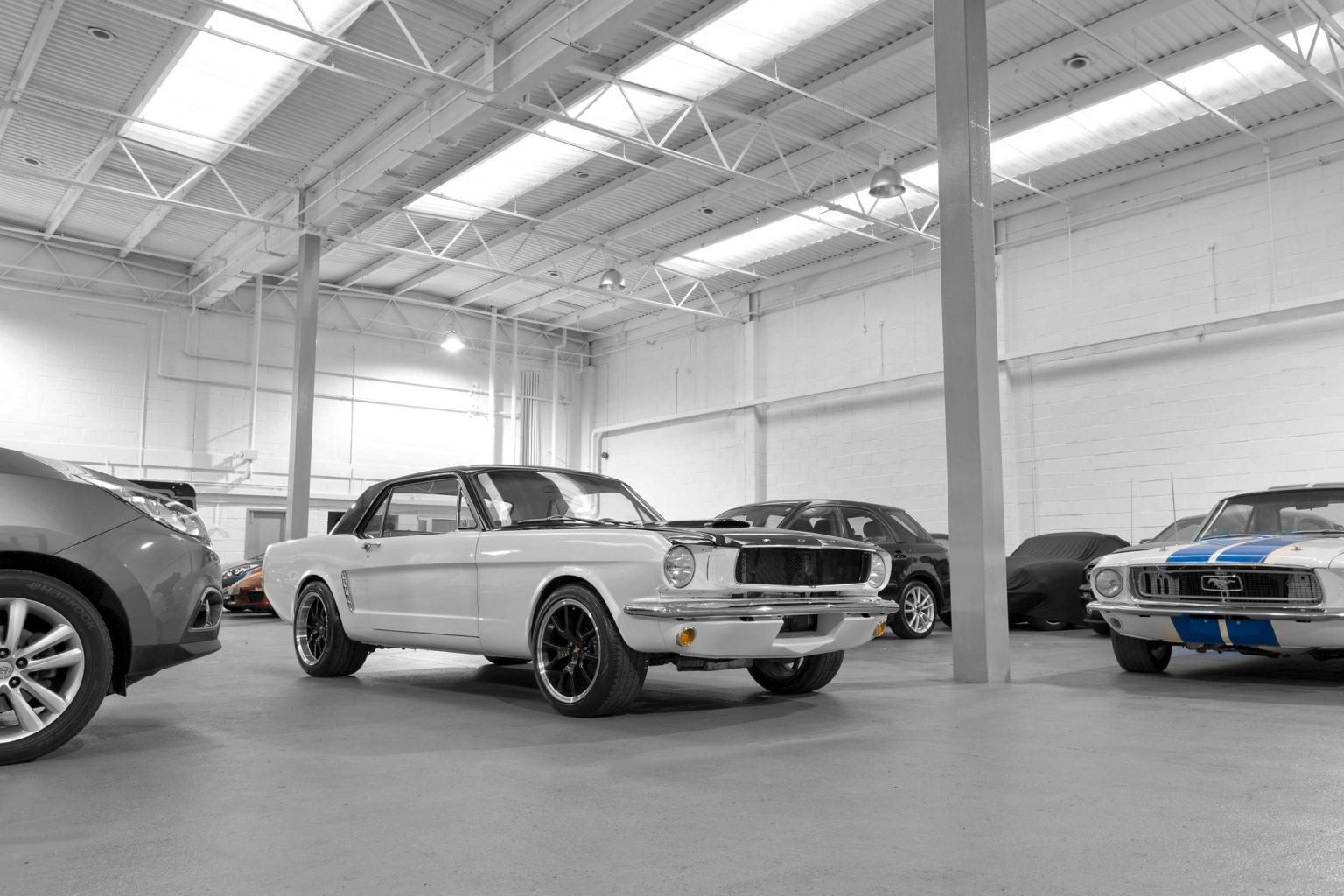 Side profile of a red 1965 Ford Mustang