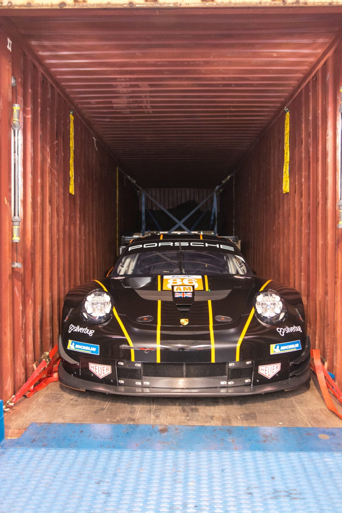 Race car loading into a container with moisture protection measures
