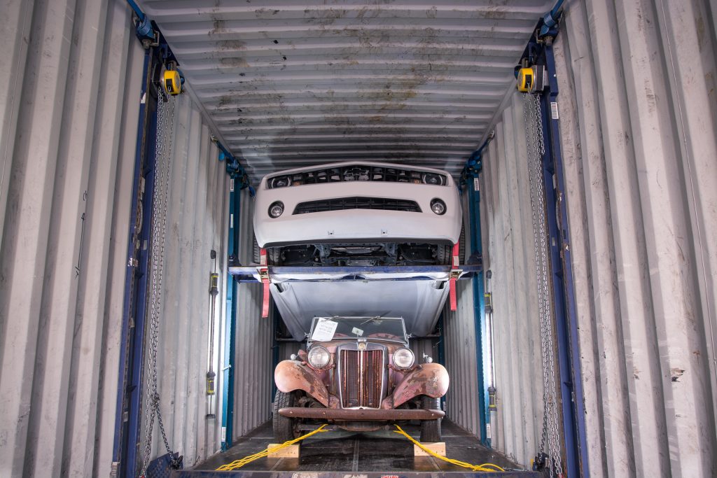 Multiple cars loaded in a 40ft container using racking